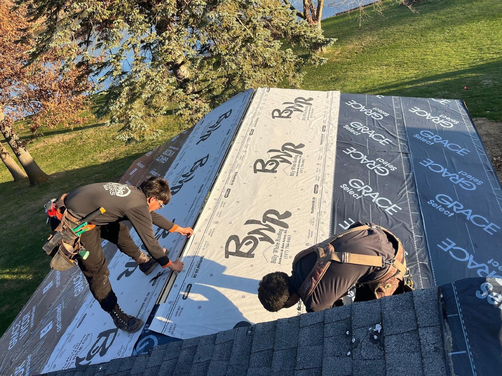 Billy White Roofing crew installing shingles